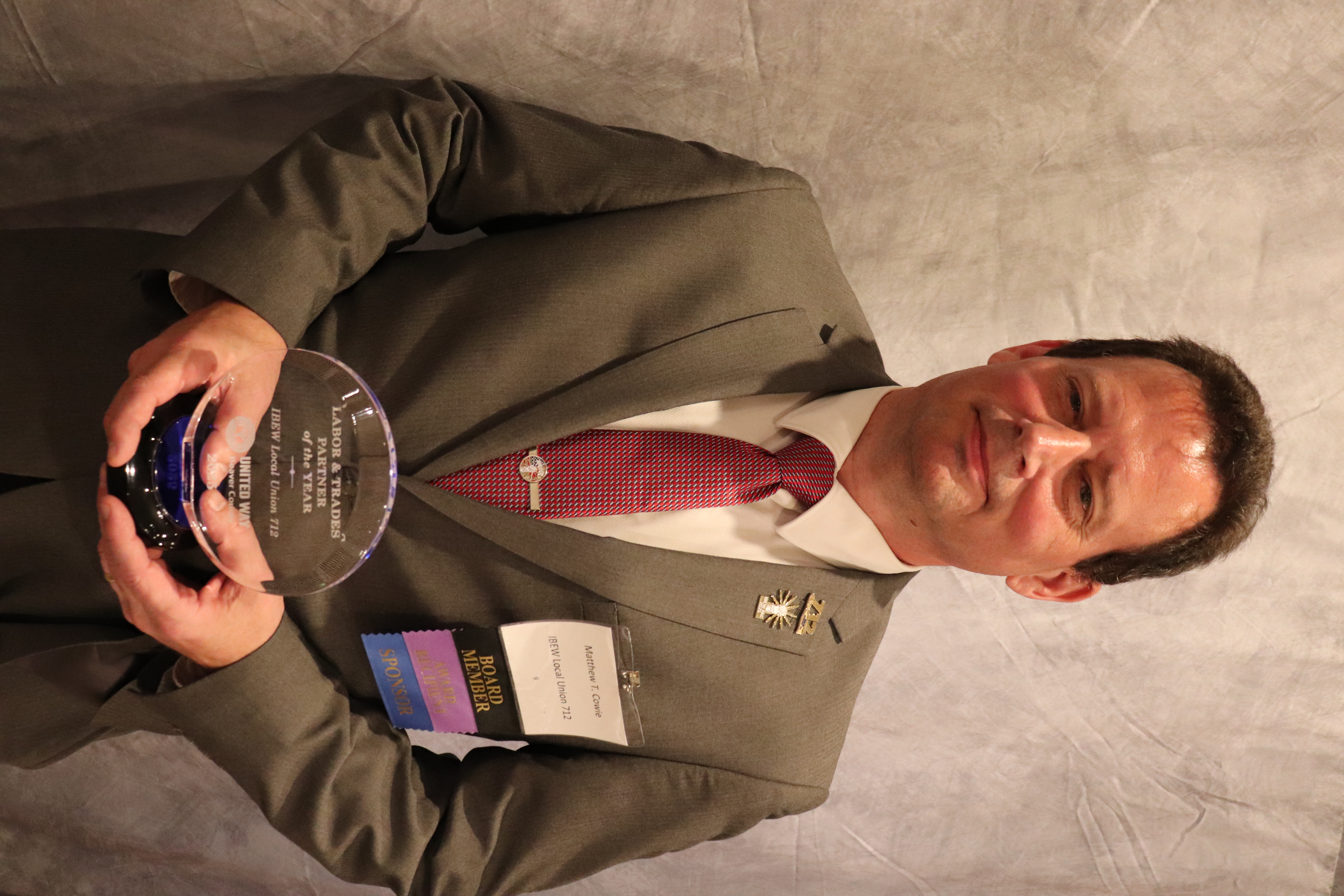 Matthew Cowie accepting the LAbor and Trades Award for IBEW Local Union #712