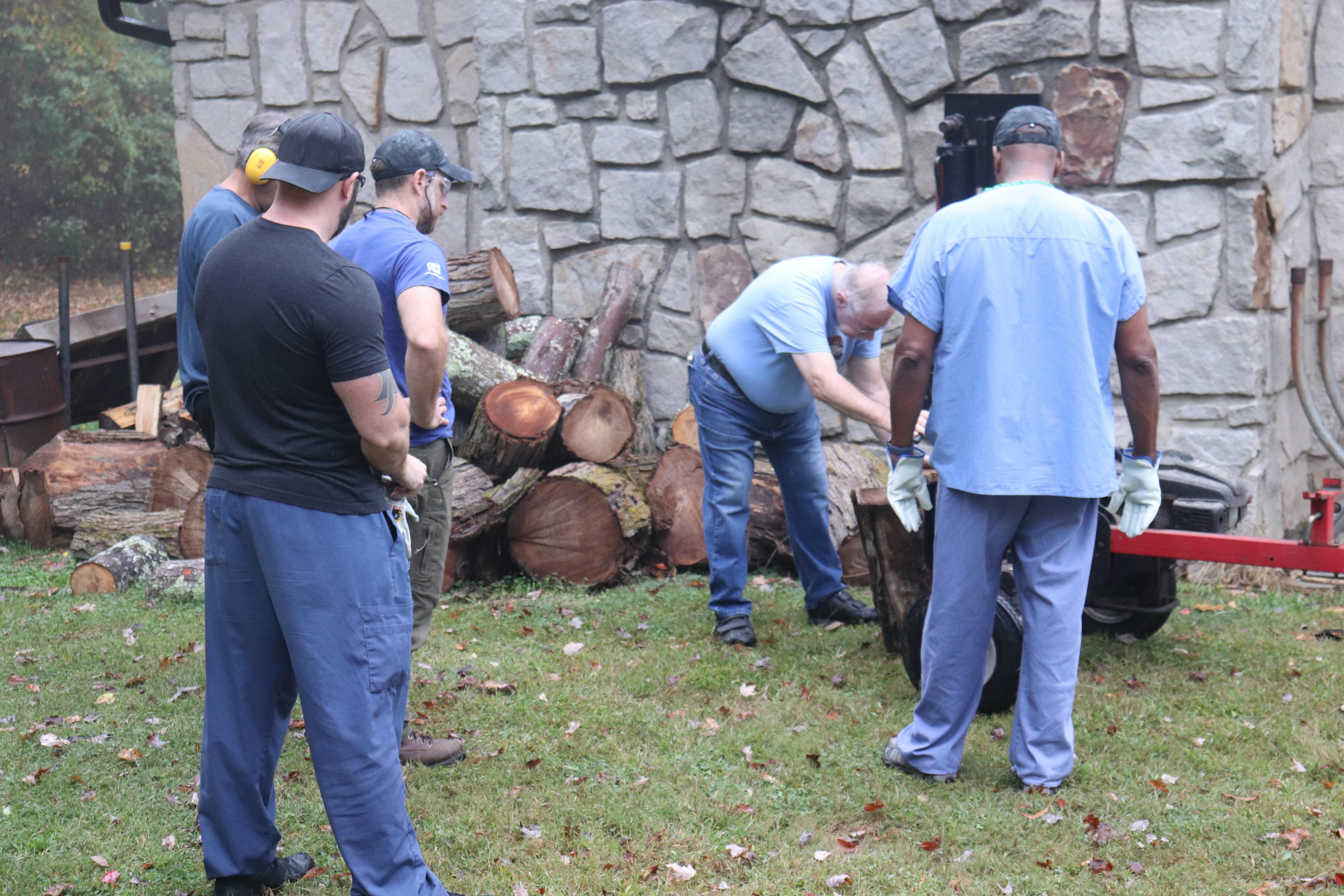 Volunteers splitting wood