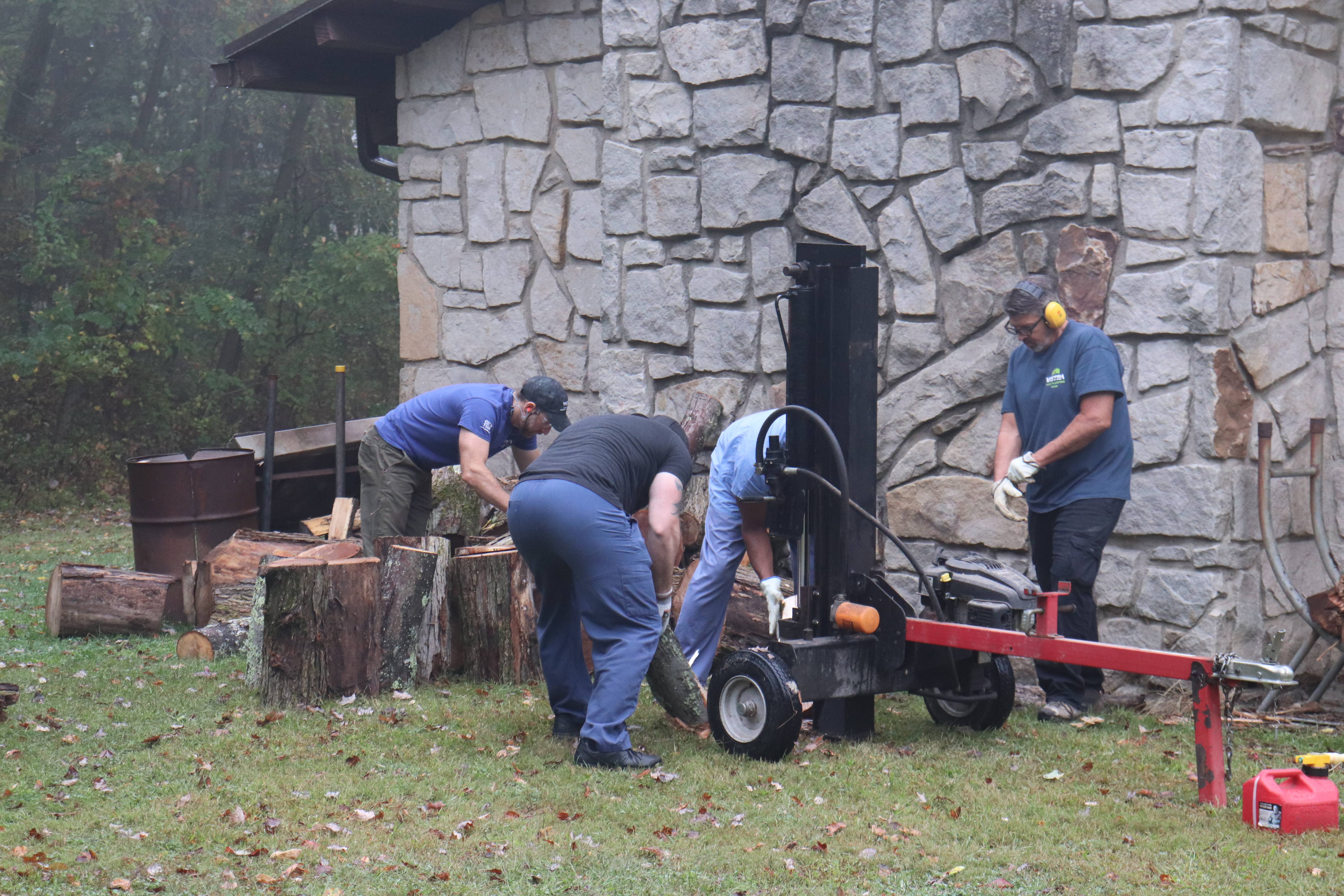 Volunteers splitting wood