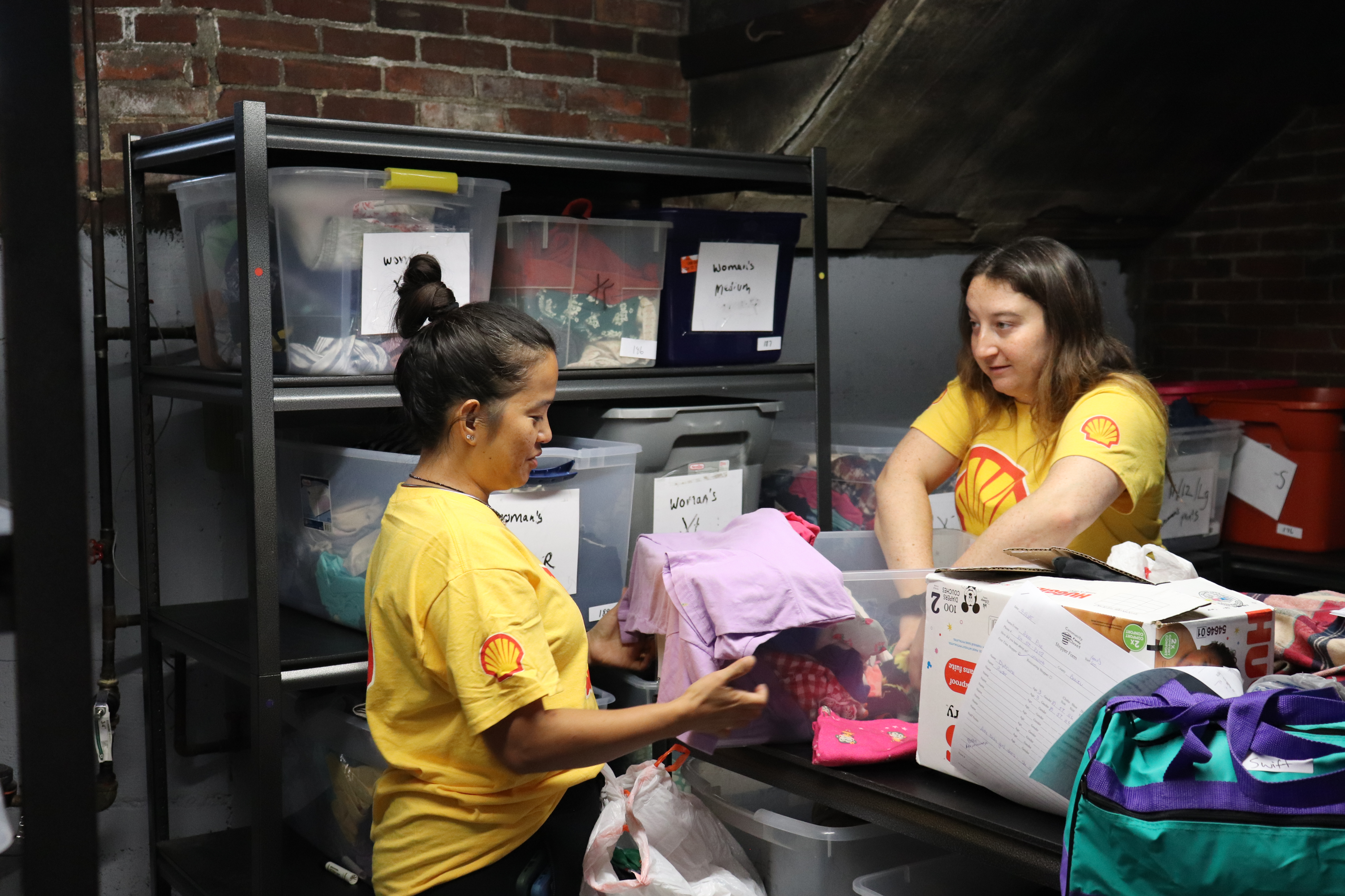 Volunteers folding clothes