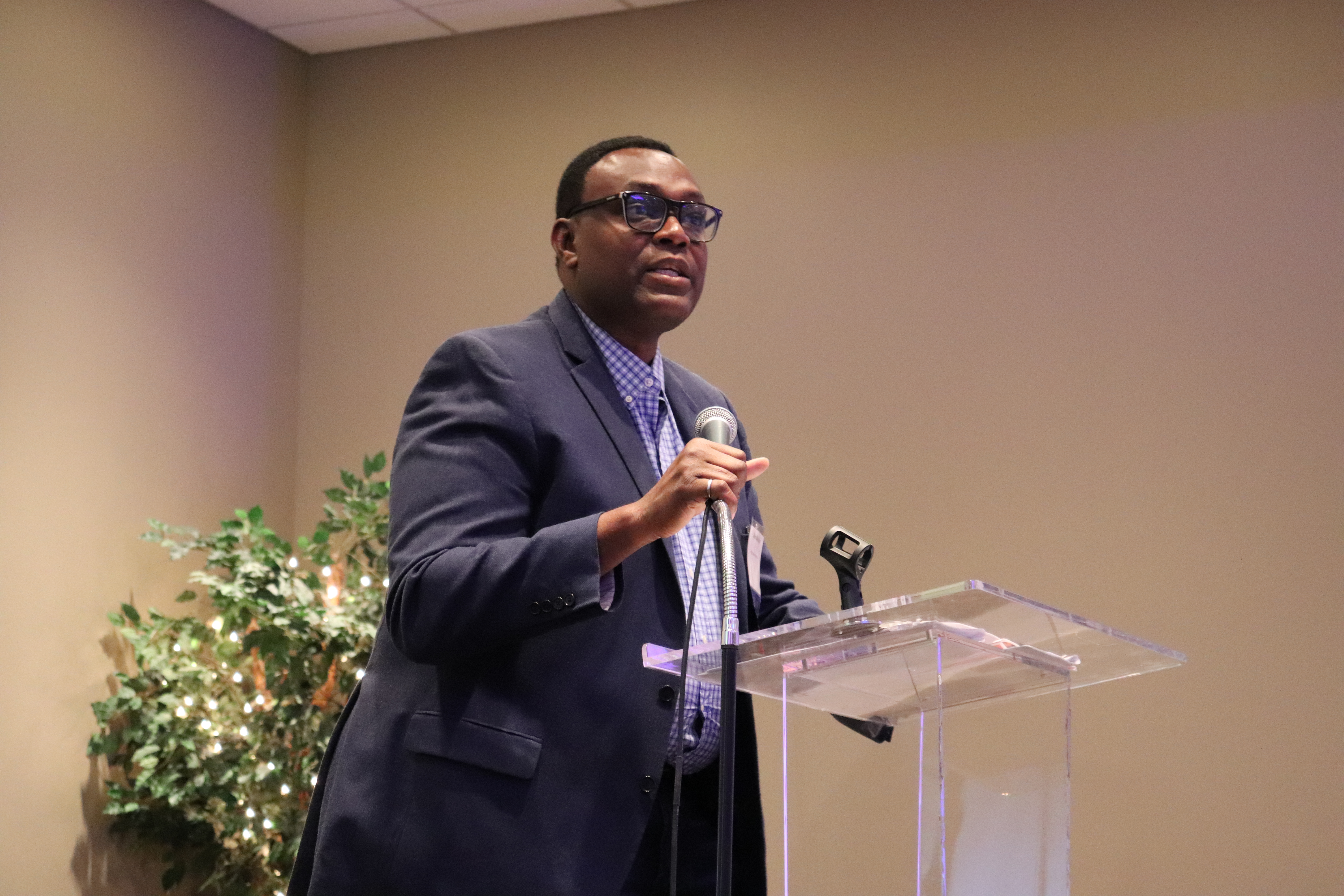 Board member Tayo Kalejaiye speaking